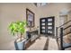 Inviting entryway boasting a modern staircase, stylish console table, and a decorative plant at 19 Hilltop Crest St, Henderson, NV 89011