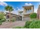 Stunning two-story home with a three-car garage, desert landscaping, and a brick driveway at 19 Hilltop Crest St, Henderson, NV 89011