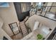 Bright foyer with wood floors, black accent wall, and staircase leading to upper level at 19 Hilltop Crest St, Henderson, NV 89011