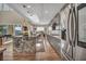 Open kitchen with a granite island, stainless appliances, and hardwood floors at 19 Hilltop Crest St, Henderson, NV 89011