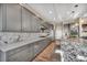 Modern kitchen featuring gray cabinetry, quartz countertops, and stainless steel appliances at 19 Hilltop Crest St, Henderson, NV 89011