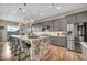 Modern kitchen featuring gray cabinets, stainless steel appliances, and a large island with seating at 19 Hilltop Crest St, Henderson, NV 89011