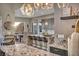 Elegant kitchen featuring a granite island with seating and modern lighting fixtures at 19 Hilltop Crest St, Henderson, NV 89011