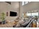 Spacious living room with high ceilings, sliding glass doors, comfortable seating, and contemporary decor at 19 Hilltop Crest St, Henderson, NV 89011