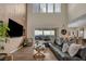 Modern living room featuring comfortable seating, a sliding glass door, and an entertainment center at 19 Hilltop Crest St, Henderson, NV 89011