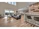 Expansive living area with bar seating, a lounge area, and floor-to-ceiling windows offering scenic views at 19 Hilltop Crest St, Henderson, NV 89011