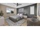 Staged main bedroom with a gray accent wall, stylish furnishings, and a beautiful outdoor view at 19 Hilltop Crest St, Henderson, NV 89011