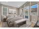 Serene staged bedroom featuring natural light, a cozy bed, and a picturesque outdoor view from the balcony at 19 Hilltop Crest St, Henderson, NV 89011