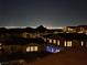 Picture shows a night view of the city and the houses in the neighborhood at 19 Hilltop Crest St, Henderson, NV 89011