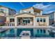 Beautiful backyard pool with an outdoor seating area and lush landscaping at 19 Hilltop Crest St, Henderson, NV 89011