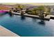 Luxury pool featuring waterfalls, lush landscaping, and a scenic view at 19 Hilltop Crest St, Henderson, NV 89011