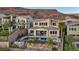 Scenic rear view of a two-story home with a pool, patio, and mountain backdrop at 19 Hilltop Crest St, Henderson, NV 89011