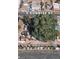 An aerial view of a home with a large tree providing shade, surrounded by cars and stored items on a gravel lot at 2510 Sunrise St, Las Vegas, NV 89101