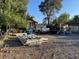 An exterior view of a home featuring a gravel area, a white pickup truck, and miscellaneous stored items at 2510 Sunrise St, Las Vegas, NV 89101