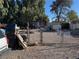 An exterior view of a home featuring a chain link fence and gravel area with miscellaneous stored items at 2510 Sunrise St, Las Vegas, NV 89101