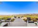 Stunning backyard view with patio seating overlooking a greenbelt and distant mountains at 31 Autumn Palm Ave, Henderson, NV 89011