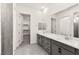 Bathroom with double sink, large mirror and walk-in closet at 31 Autumn Palm Ave, Henderson, NV 89011