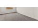 Neutral bedroom featuring gray carpeting, white walls and baseboards, and a window at 31 Autumn Palm Ave, Henderson, NV 89011
