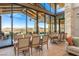 Beautiful great room with hardwood floors, large windows with mountain views, and dining and seating areas at 31 Autumn Palm Ave, Henderson, NV 89011