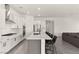 Modern kitchen showcasing white cabinetry, a gray island with seating, and stainless steel appliances at 31 Autumn Palm Ave, Henderson, NV 89011
