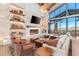 Open-concept living room featuring a fireplace, built-in shelves, and floor-to-ceiling windows with mountain views at 31 Autumn Palm Ave, Henderson, NV 89011