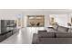 Bright living room featuring a large sofa and sliding glass doors to the backyard patio at 31 Autumn Palm Ave, Henderson, NV 89011