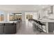 Open-concept living space with a spacious kitchen island and seamless flow to the patio at 31 Autumn Palm Ave, Henderson, NV 89011