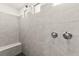 Walk in shower with grey tile and a built-in bench at 31 Autumn Palm Ave, Henderson, NV 89011