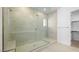 Modern bathroom featuring a glass-enclosed shower with tiled walls, a built-in bench, and tile floors at 352 Tigullio Ave, Henderson, NV 89011