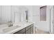 Modern bathroom with double sinks, gray cabinets, quartz countertop, and a glass shower door at 352 Tigullio Ave, Henderson, NV 89011