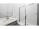 Modern bathroom with a glass shower, gray vanity, white sink, and sleek fixtures at 352 Tigullio Ave, Henderson, NV 89011