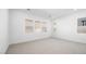 Spacious bedroom with carpet flooring and multiple windows, providing natural light and views at 352 Tigullio Ave, Henderson, NV 89011