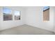 Bright, carpeted bedroom with three windows offering ample natural light and neutral decor at 352 Tigullio Ave, Henderson, NV 89011