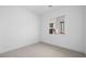 Bright bedroom features neutral carpet, white walls, and a window offering natural light at 352 Tigullio Ave, Henderson, NV 89011