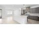 Modern kitchen has a white island, gray cabinets, and tile floors at 352 Tigullio Ave, Henderson, NV 89011