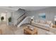 Bright living room with staircase, soft neutral colors, and wood-look flooring at 4165 Mississippi Ave, Las Vegas, NV 89103