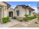 Elegant front entrance with a gated courtyard, lush landscaping, and stone pathway at 730 Puerto Real Ct, Las Vegas, NV 89138