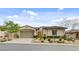 Charming single-story home with a two-car garage and beautiful desert landscaping at 730 Puerto Real Ct, Las Vegas, NV 89138
