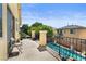 Balcony with railing overlooking the backyard pool and lush greenery at 10437 Walworth Ave, Las Vegas, NV 89166