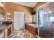Bathroom featuring a soaking tub, glass shower, and unique tile flooring at 10437 Walworth Ave, Las Vegas, NV 89166