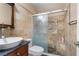 Bathroom with granite vanity and stone and tile shower featuring bench and decorative tile art at 10437 Walworth Ave, Las Vegas, NV 89166