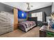 Bedroom with striped bedspread, study space and gray walls, with a unique chandelier and storage space at 10437 Walworth Ave, Las Vegas, NV 89166