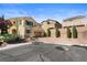 Inviting two-story home with tan stucco, shutters, desert landscaping, and a two car garage at 10437 Walworth Ave, Las Vegas, NV 89166
