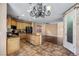 Bright kitchen with tile floors, wooden cabinets, stainless steel appliances and view to backyard at 10437 Walworth Ave, Las Vegas, NV 89166