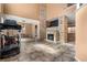 Bright living room featuring tile flooring, a stone fireplace, and ample natural light at 10437 Walworth Ave, Las Vegas, NV 89166