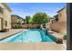 Sparkling in-ground pool surrounded by a concrete patio and manicured landscaping at 10437 Walworth Ave, Las Vegas, NV 89166