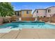 Inviting backyard pool with sun shelf and lush landscaping at 10437 Walworth Ave, Las Vegas, NV 89166
