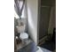 Bathroom featuring a toilet next to a shower with a glass door and a small window at 2112 Hollow Oak Ave, North Las Vegas, NV 89031