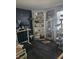 Nicely decorated bedroom featuring a desk, shelving and dark laminate flooring at 2112 Hollow Oak Ave, North Las Vegas, NV 89031