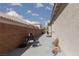 A partially shaded patio, enclosed by a sturdy block wall, provides outdoor privacy at 2691 Rimpacific Cir, Las Vegas, NV 89146